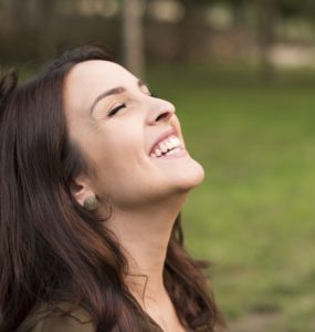 Happy woman outside smiling