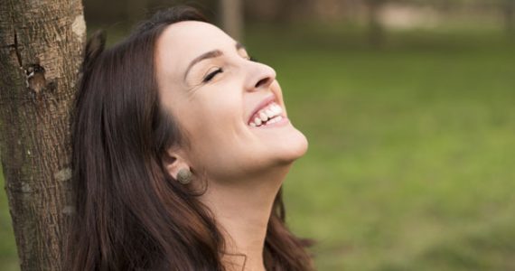 Happy woman outside smiling