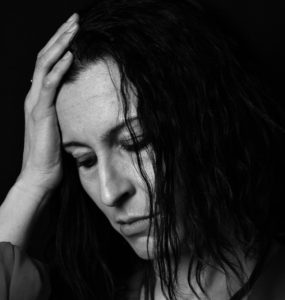 Close up of woman in black and white looking sad