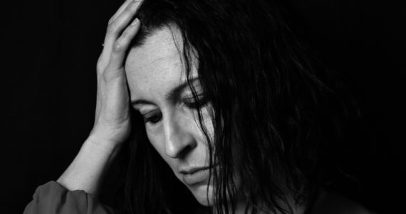 Close up of woman in black and white looking sad