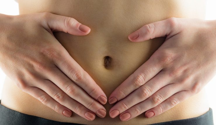 CLose up of hands on tummy to represent indigestion
