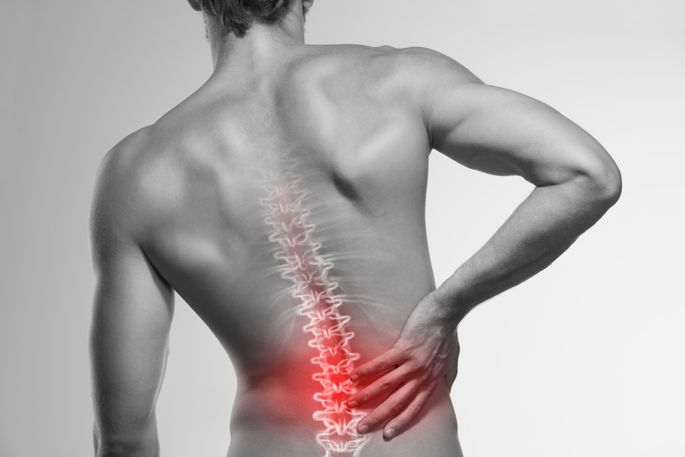 A black and white picture of a man's back with the spine and lower back highlighted red to represent back pain