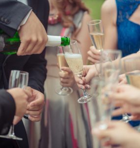 Close up of someone pouring a glass of champagne