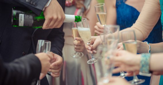 Close up of someone pouring a glass of champagne
