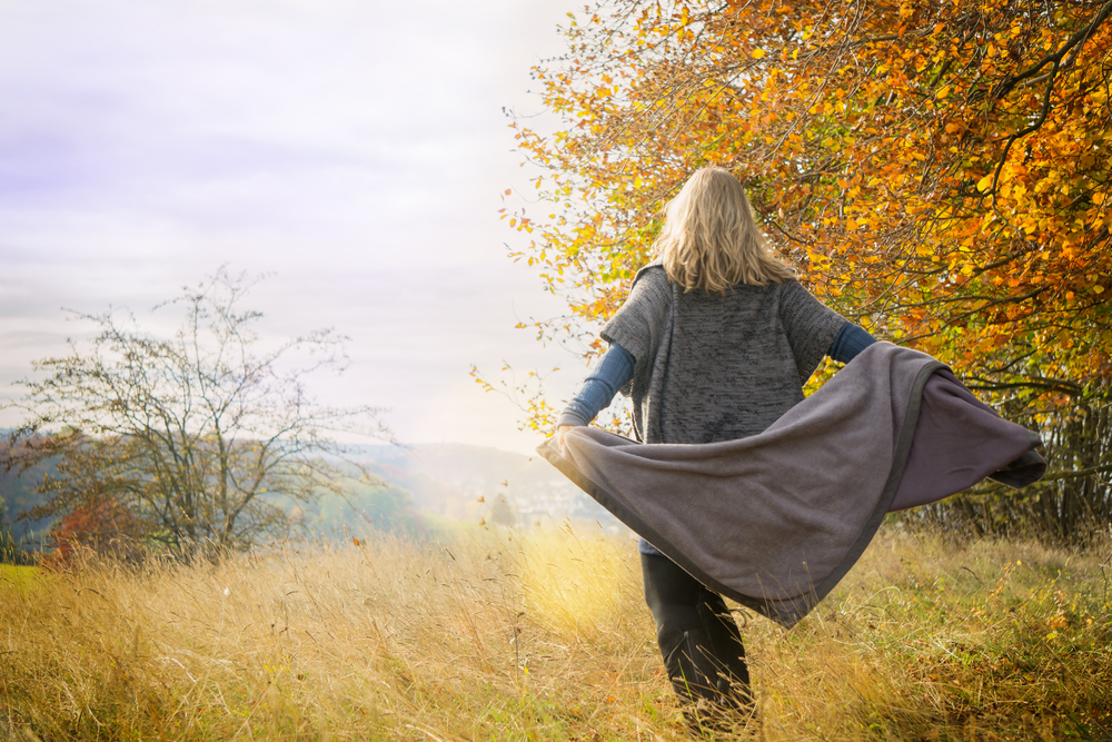 Woman outside in autumn dancing