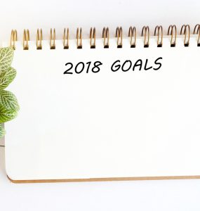 A note pad with 2018 goals written at the top in order to plan health goals