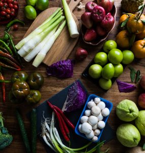 A selection of fruit and vegetables laid out on a table