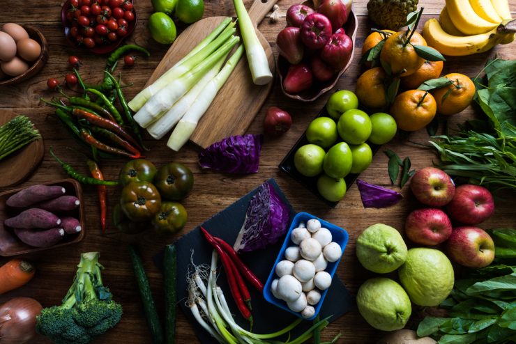 A selection of fruit and vegetables laid out on a table