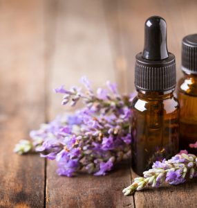 Lavender flower and aromatherapy oils on wooden table
