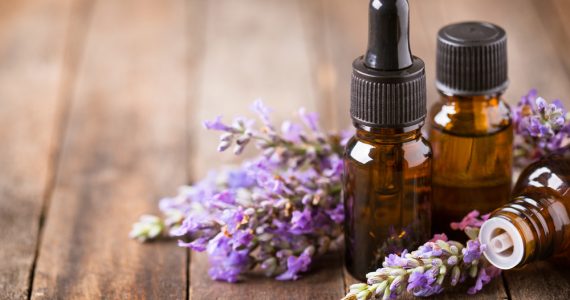 Lavender flower and aromatherapy oils on wooden table