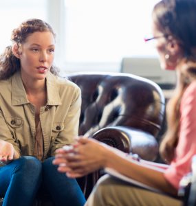 Two women talking to represent sharing problems to support mental health