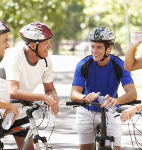 A group of men on bicyles stopping for a chat