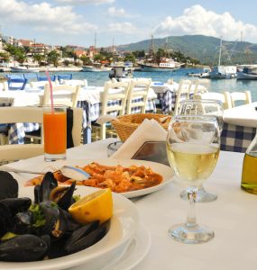 A restaurant table overlooking a harbour in france