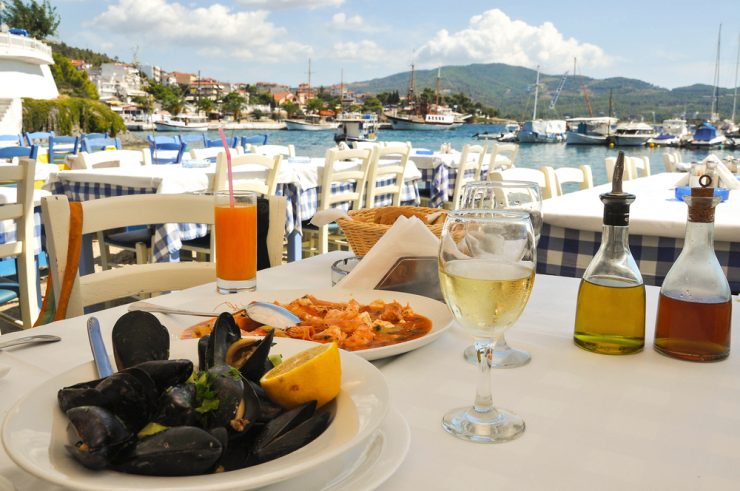 A restaurant table overlooking a harbour in france