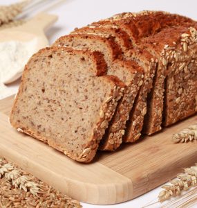 Wholewheat bread loaf with a scoop of flour