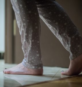 Close up of woman in pyjamas visiting the bathroom at night