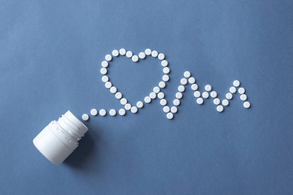 Antibiotics shaped into a heart and pulse line