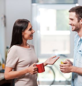 Two people talking while getting a coffee