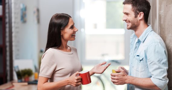 Two people talking while getting a coffee