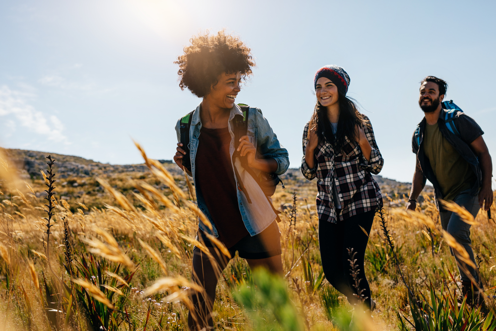 Friends hiking through the coutryside on a sunny day