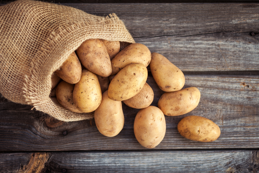 Small sack with potatoes falling out