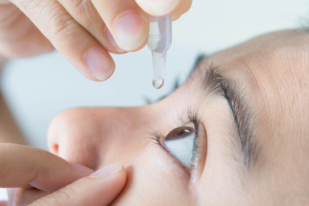 CLose up of woman using eye drops