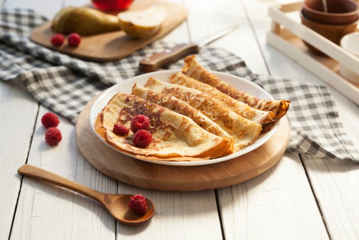 A plate of pancakes with berries