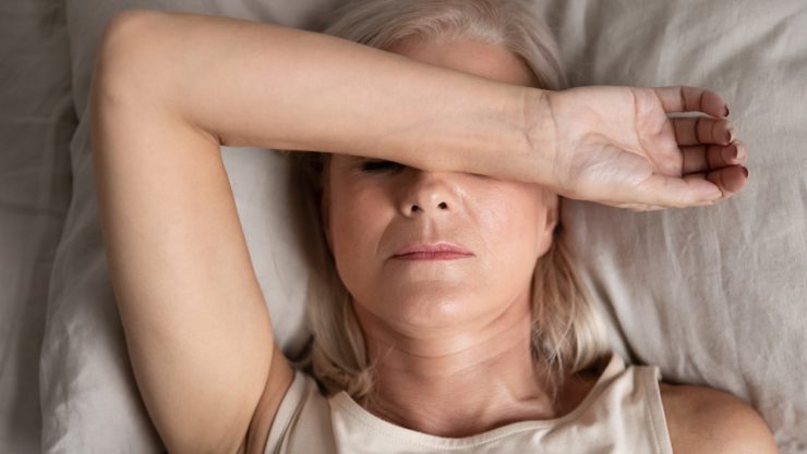 Close up of middle aged woman in bed struggling to sleep