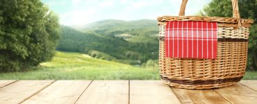 IMage of a picnic basket overlooking the countryside
