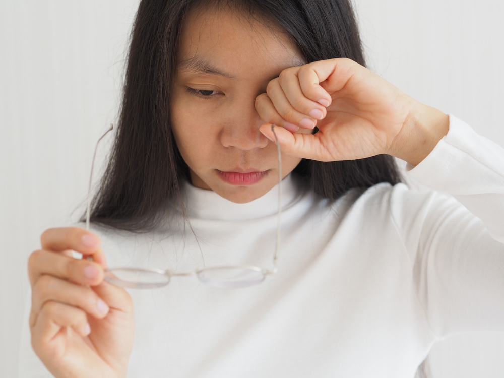 Woman rubbing her eye