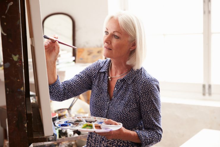 Middle aged woman painting