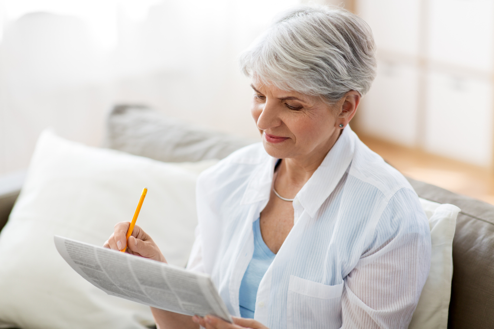 Older woman doing a crossword