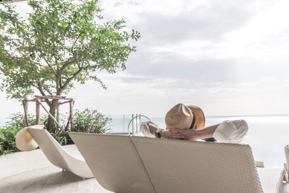 Image of woman relaxing on holiday looking out at the sea