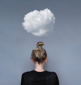 Woman with small cloud overhead to represent mental health worries
